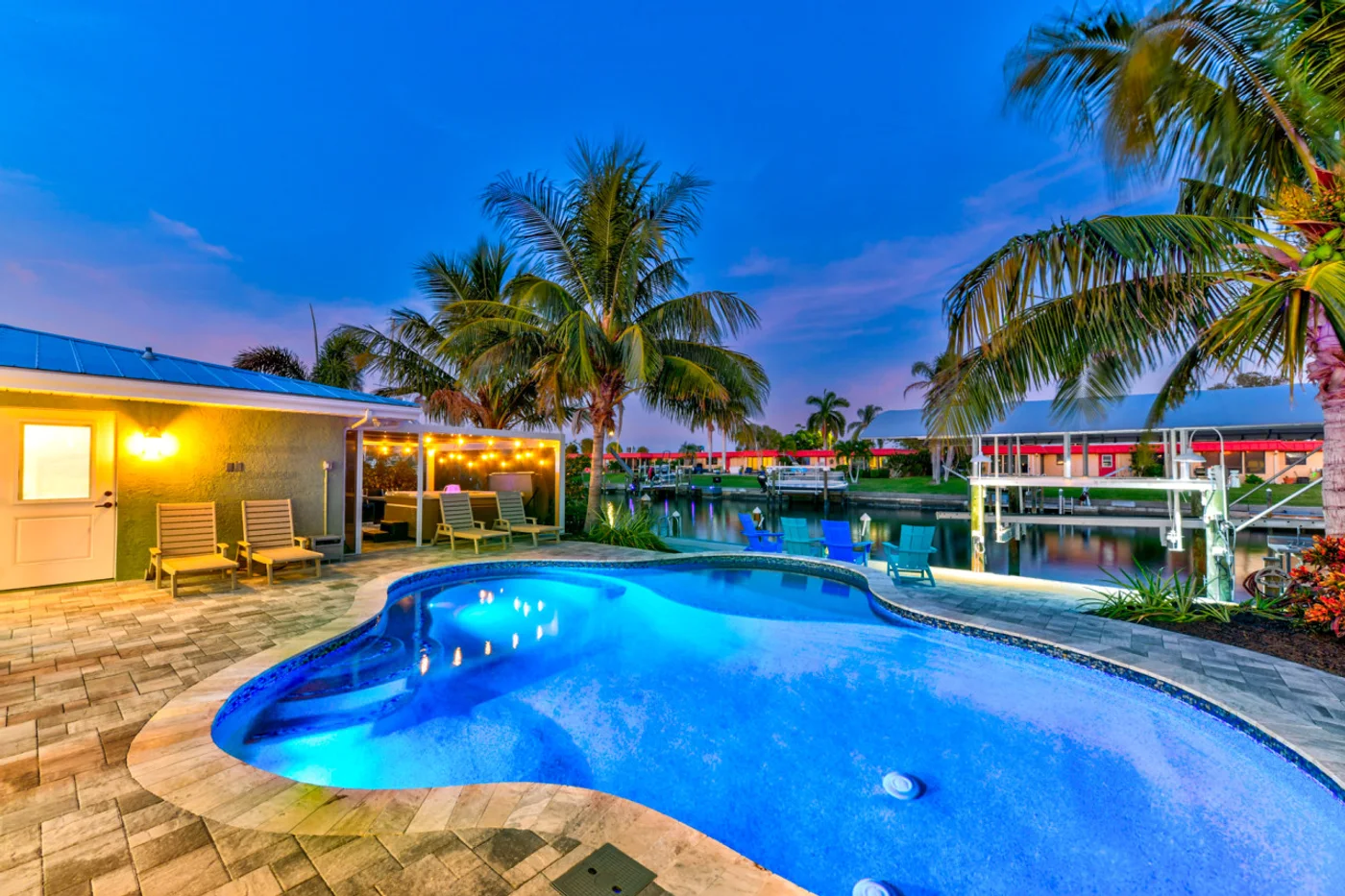 Dockside Dreams — Pool and patio at dusk