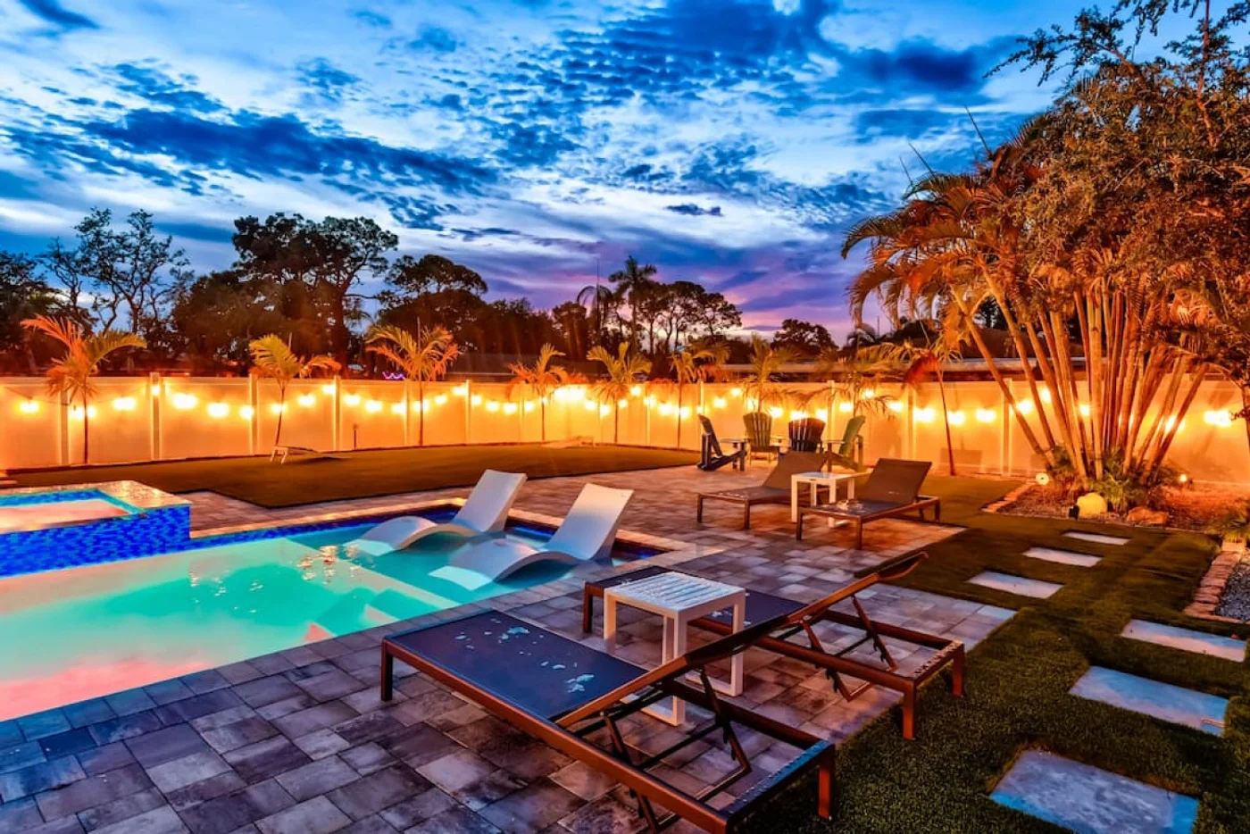 The Oasis — Pool and backyard at dusk
